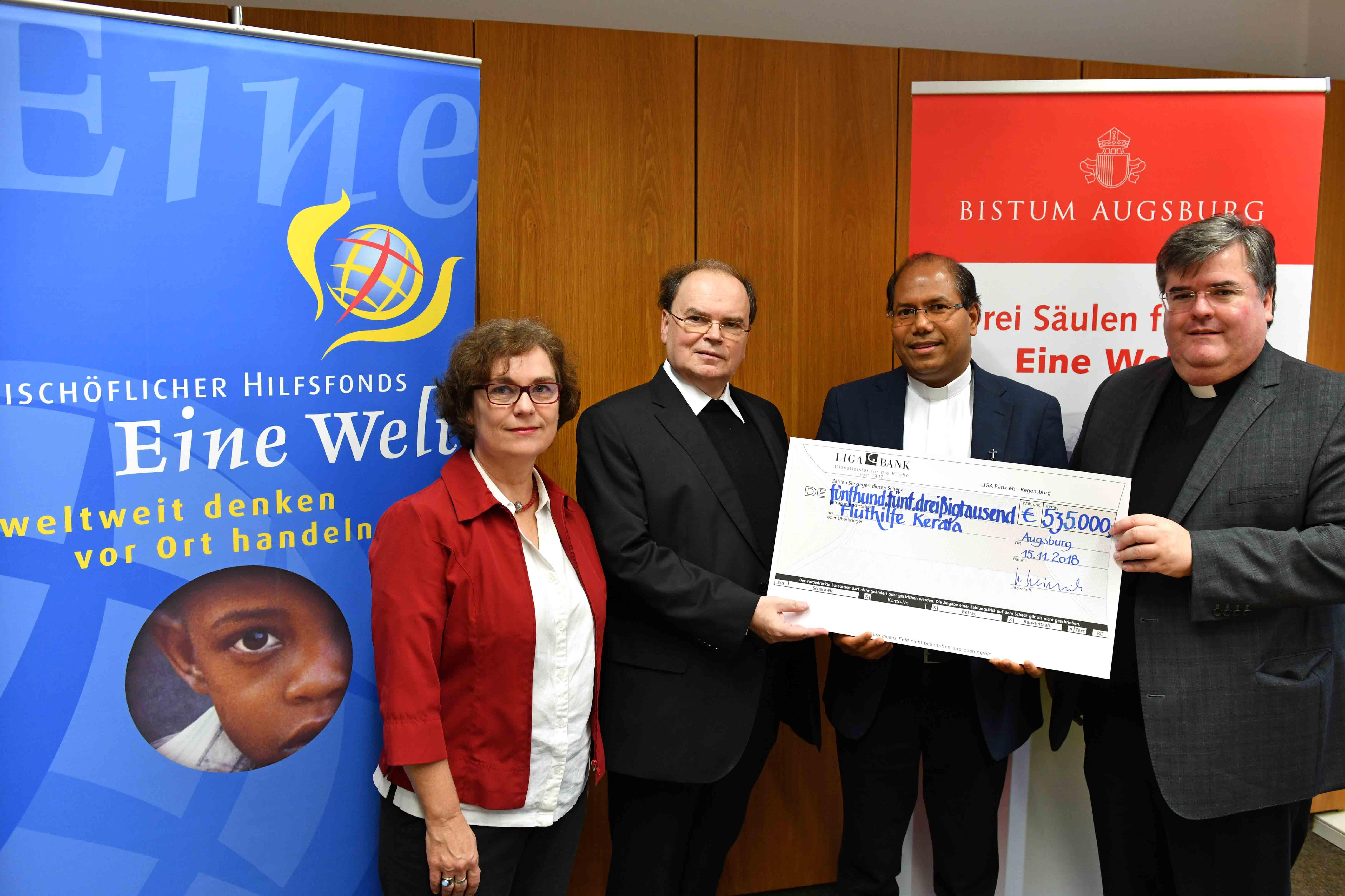 Bei der symbolischen Scheckübergabe an Pater Michael Darlyvilla: Generalvikar Msgr. Harald Heinrich, Domdekan Prälat Dr. Bertram Meier als Vorsitzender des Stiftungsrates des Bischöflichen Hilfsfonds Eine Welt und Andrea Decke als Stiftungsvorstand. (Foto: Nicolas Schnall / pba)