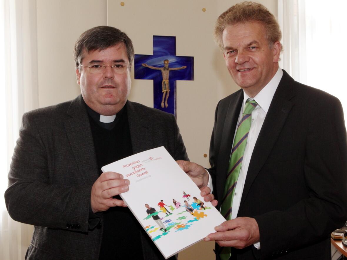 Soeben hat Generalvikar Harald Heinrich das erste Exemplar der Handreichung an Pastoralreferent Bernhard Scholz überreicht. Er leitet die diözesane Koordinationsstelle zur Prävention gegen sexualisierte Gewalt. (Foto: Annette Zoepf/pba)
