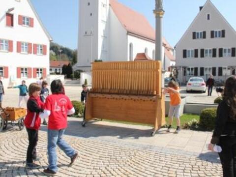 Zwei Buben betätigen die "größte Rätsche der Welt".