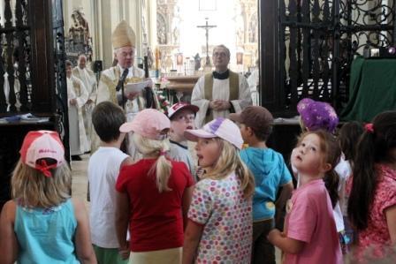 Weihbischof Dr. Dr. Anton Losinger begrüßte über 250 Kinder am Eingang der Basilika St. Ulrich und Afra in Augsburg.